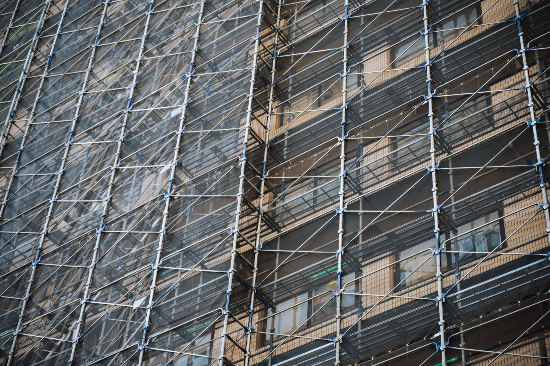 Caffolding on the facade of modern architecture building for renovate and reapring exterior problem in tokyo Japan