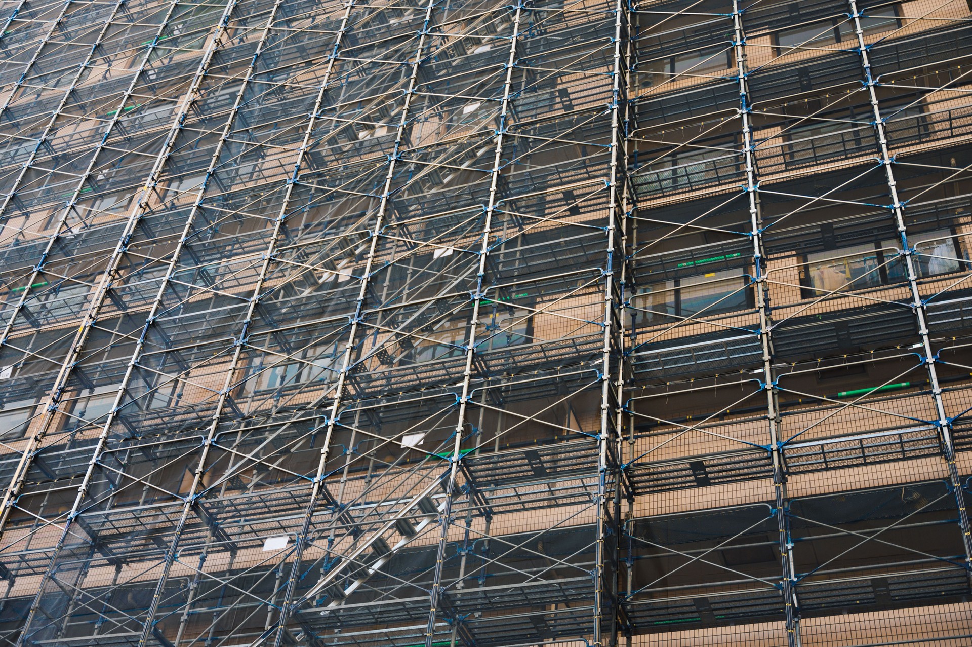 Caffolding on the facade of modern architecture building for renovate and reapring exterior problem in tokyo Japan